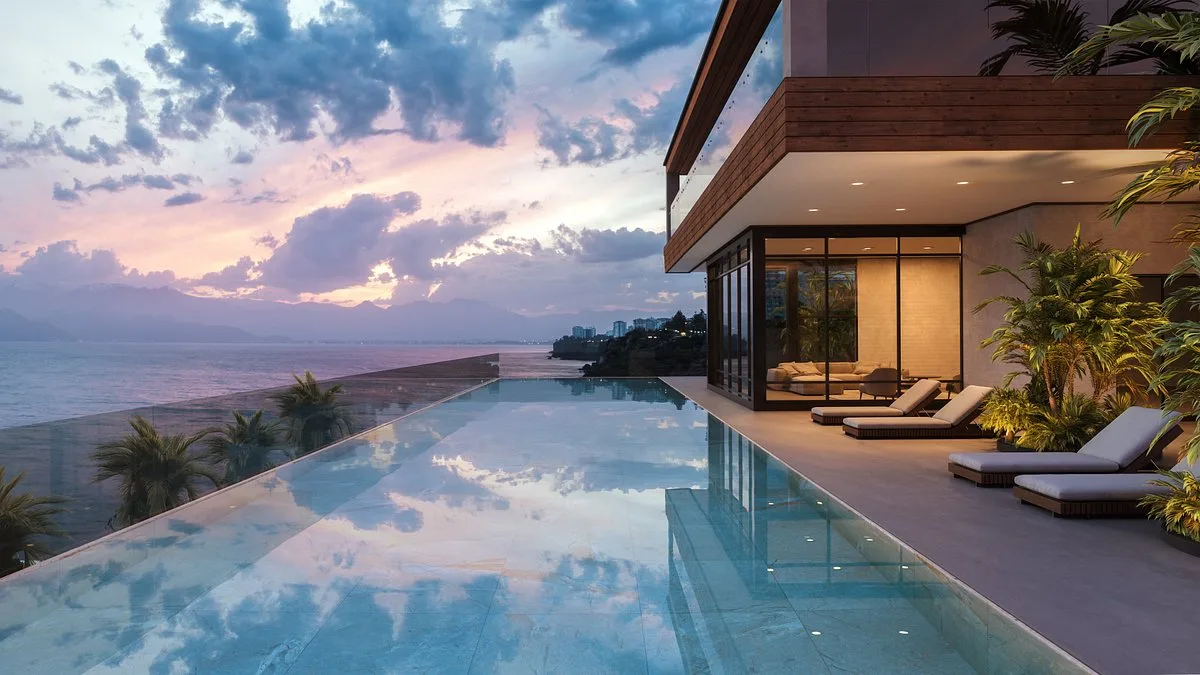 A pool at dusk looking out over the coast