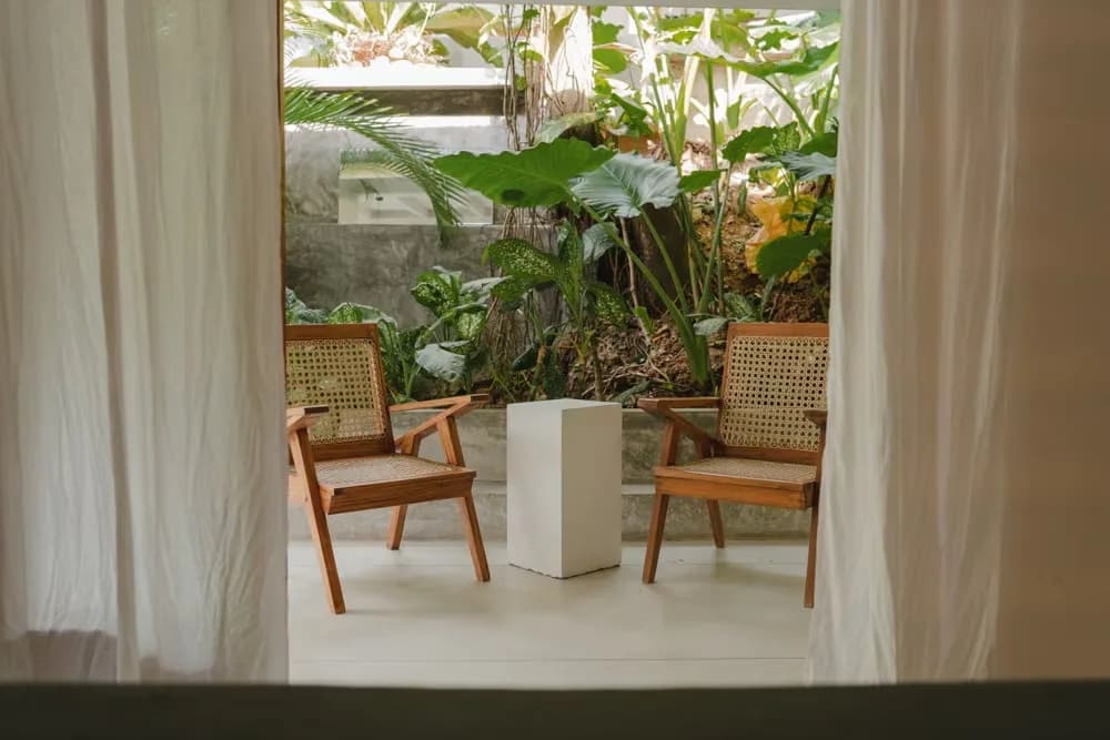 Chairs in the shade of the veranda at Arana Villa